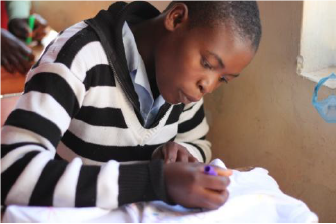 young boy writing