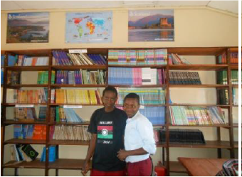 two boys in front of book shelf